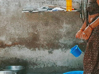 In the country's douche of the village, the senior sister-in-law's sister in law is soddening her saree in water and bathi