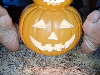 Demonstrating off our feet next to the pumpkin