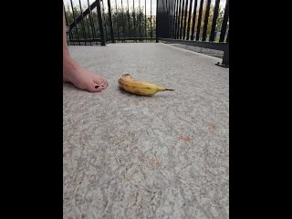 Erotically punching a banana with my nice nude soles outside