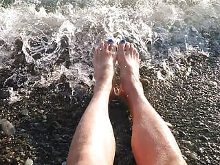 On public beach I sit on the shore dressed in cutoffs and tee-shirt and soaking my soles in the river ...